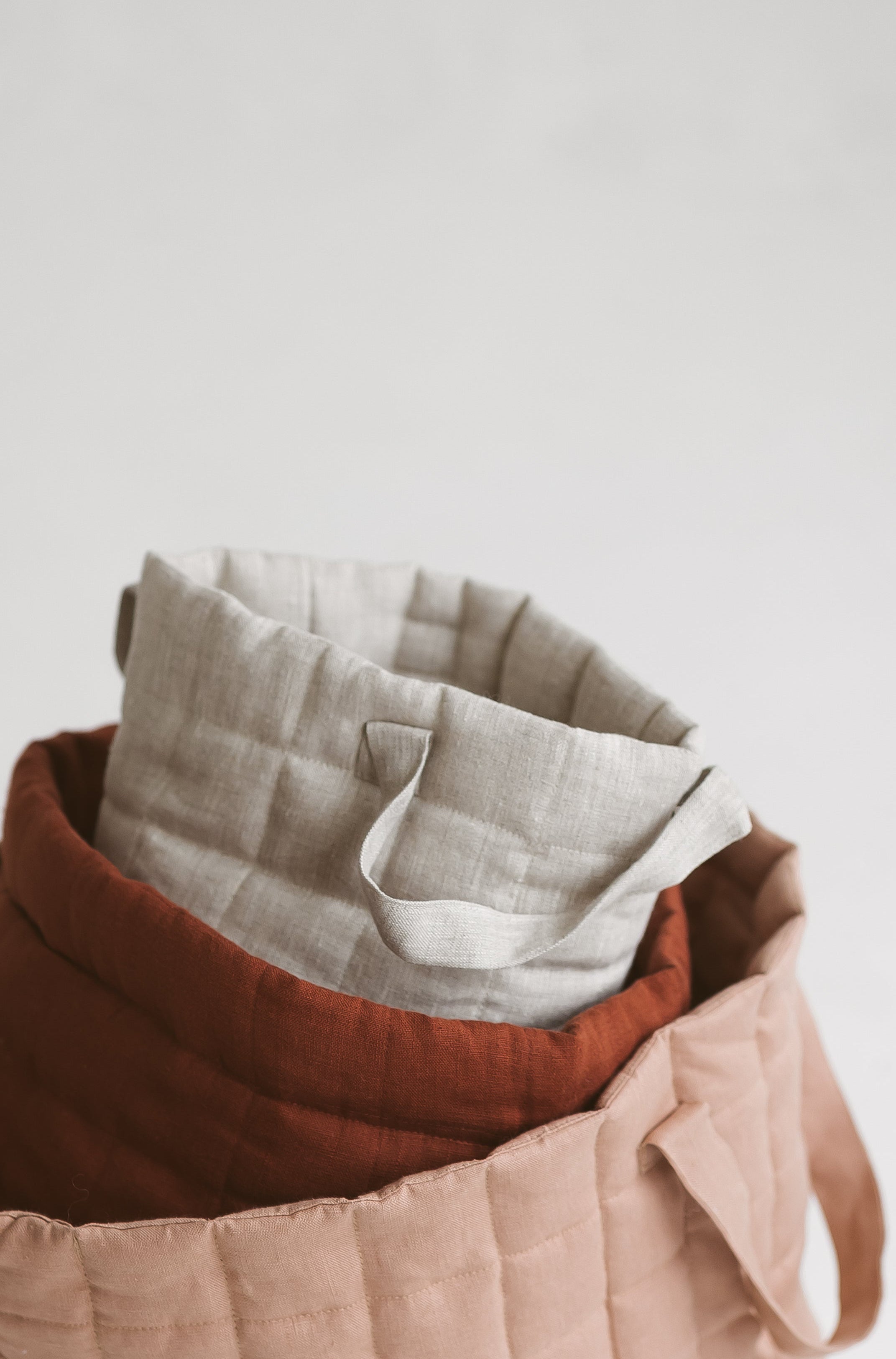 beige quilted linen laundry basket