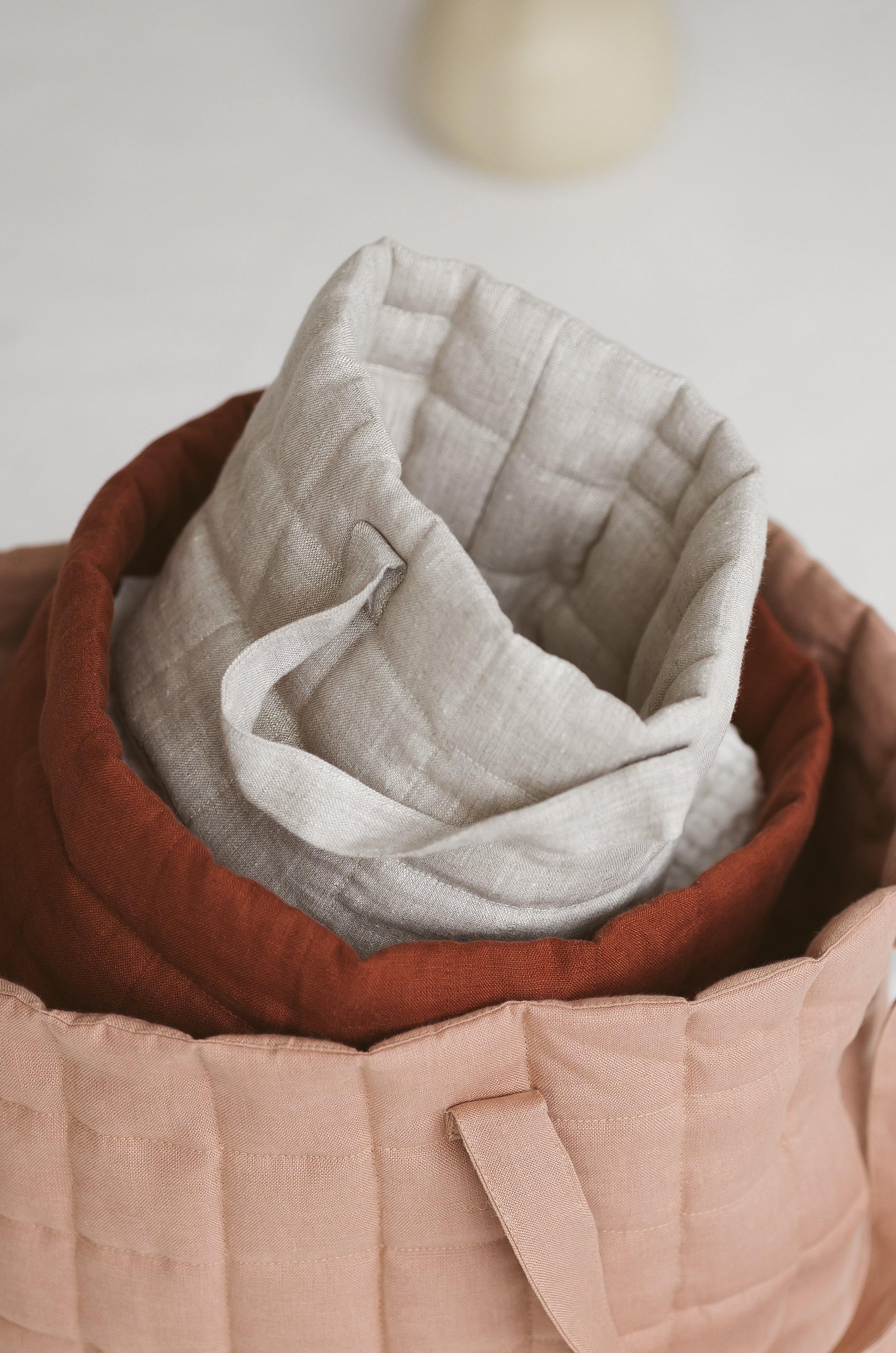 beige quilted linen laundry basket
