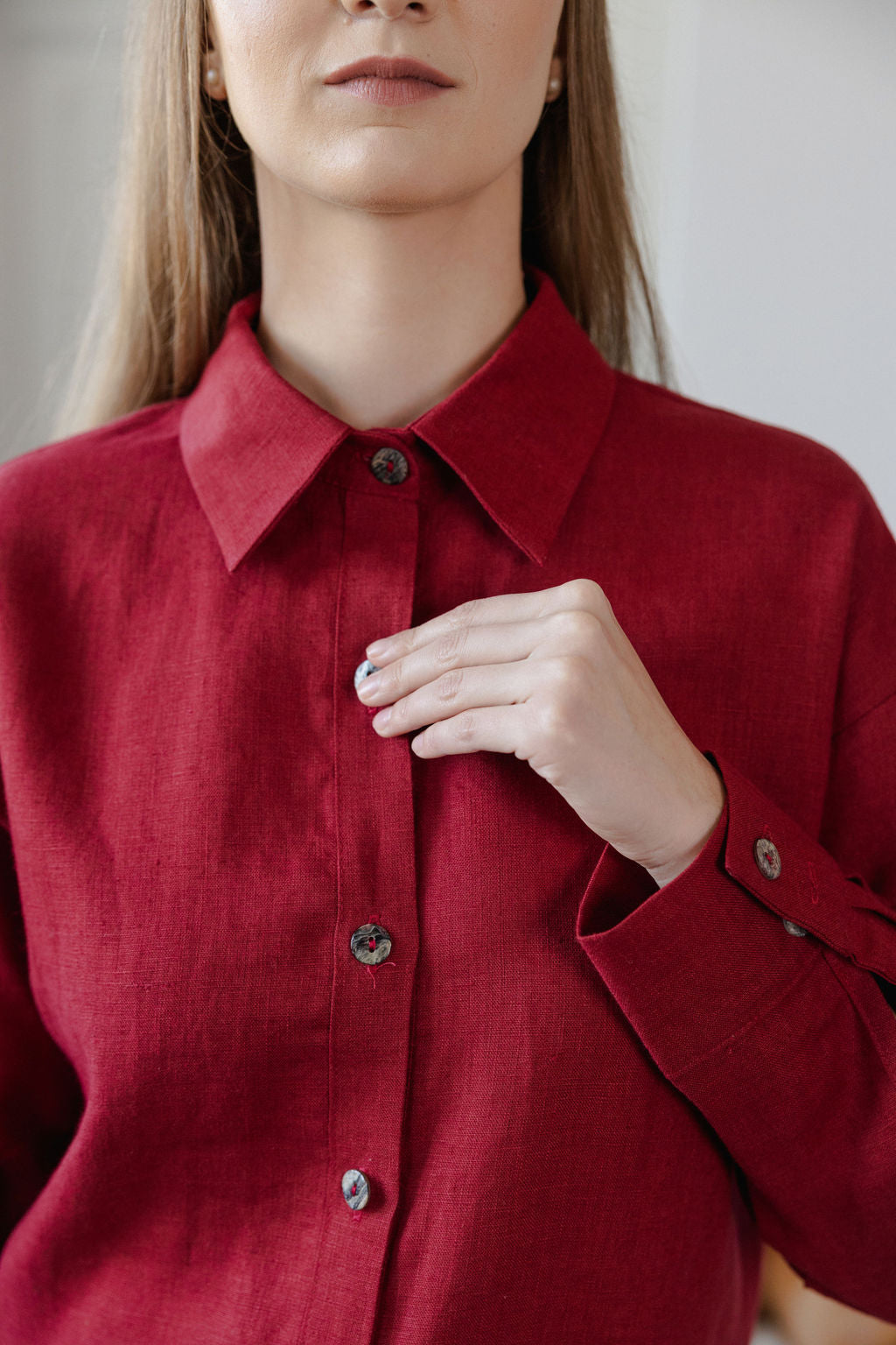 Person wearing a red shirt with a neutral background