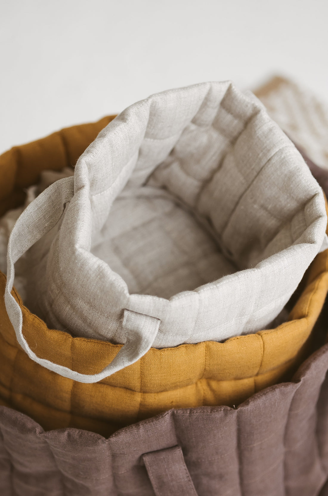beige quilted linen laundry basket