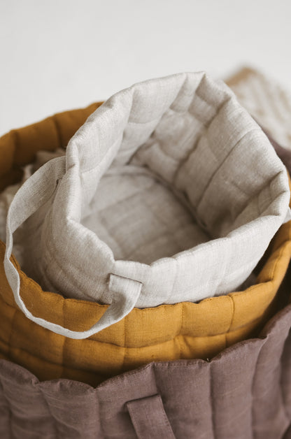 beige quilted linen laundry basket