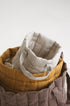 beige quilted linen laundry basket